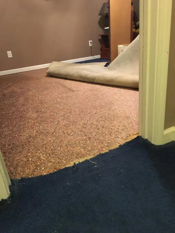 Carpet pad removal revealing water damage during Drying & Dehumidification in Owasso